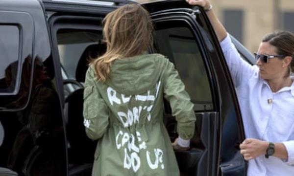 woman in khaki jacket that says ‘i really don’t care, do U?’ on the back